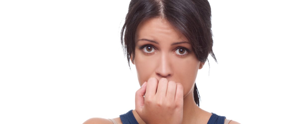 Head shot of worried woman over white background